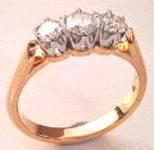 three stone claw set gold ring